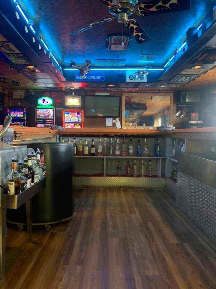 Back bar with Harley-Davidson sign and blue neon