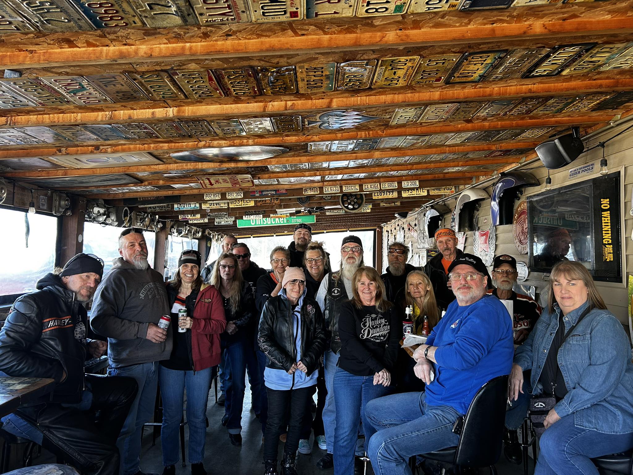 Crowd in the beer garden with license plates covering the ceiling