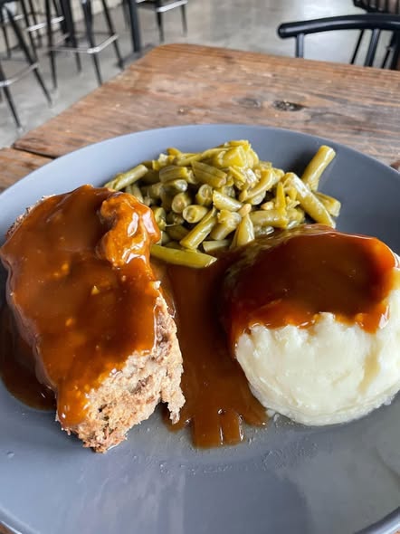 Meatloaf dinner with mashed potatoes, gravy, and green beans