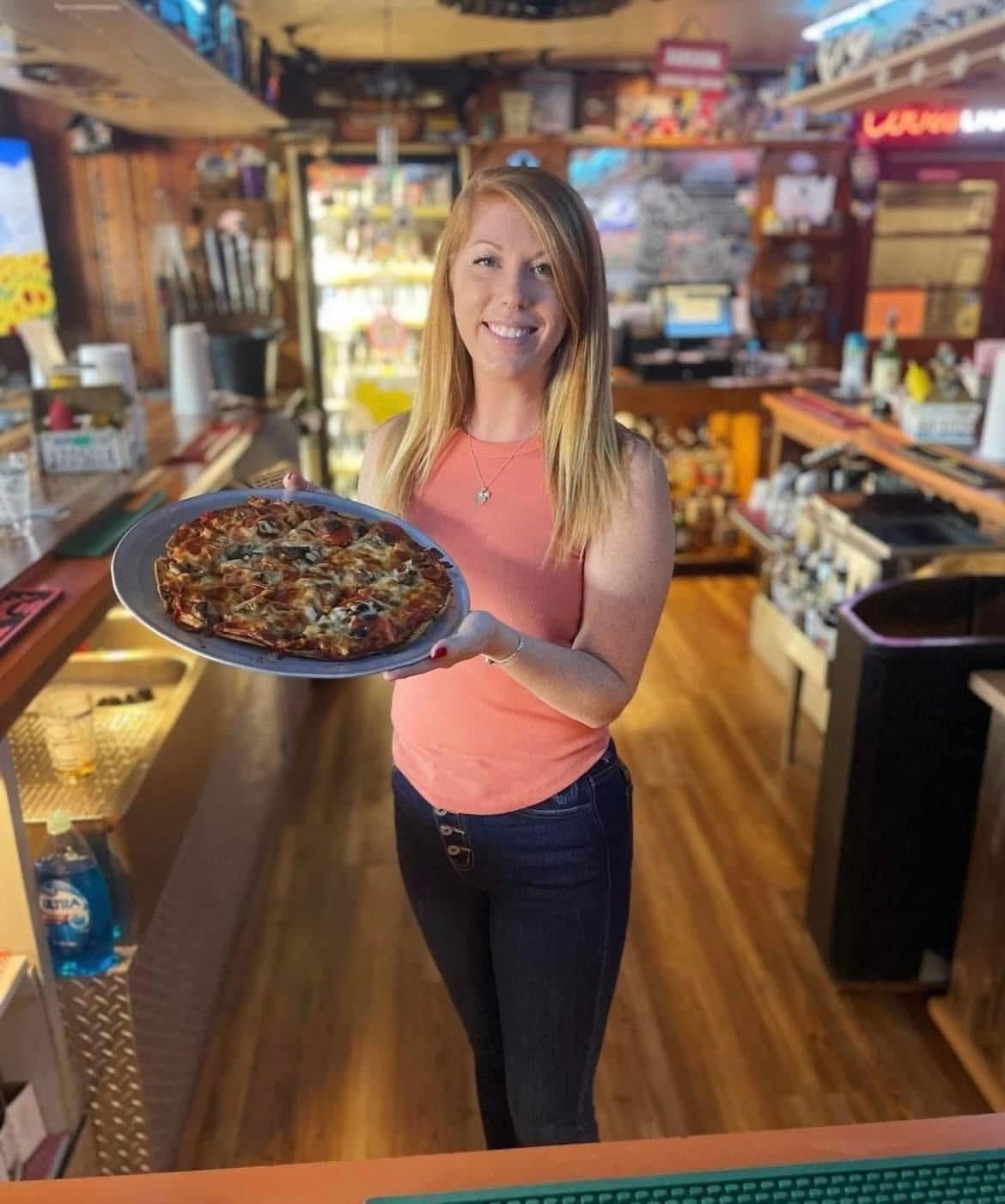 Vanessa serving up a fresh pizza