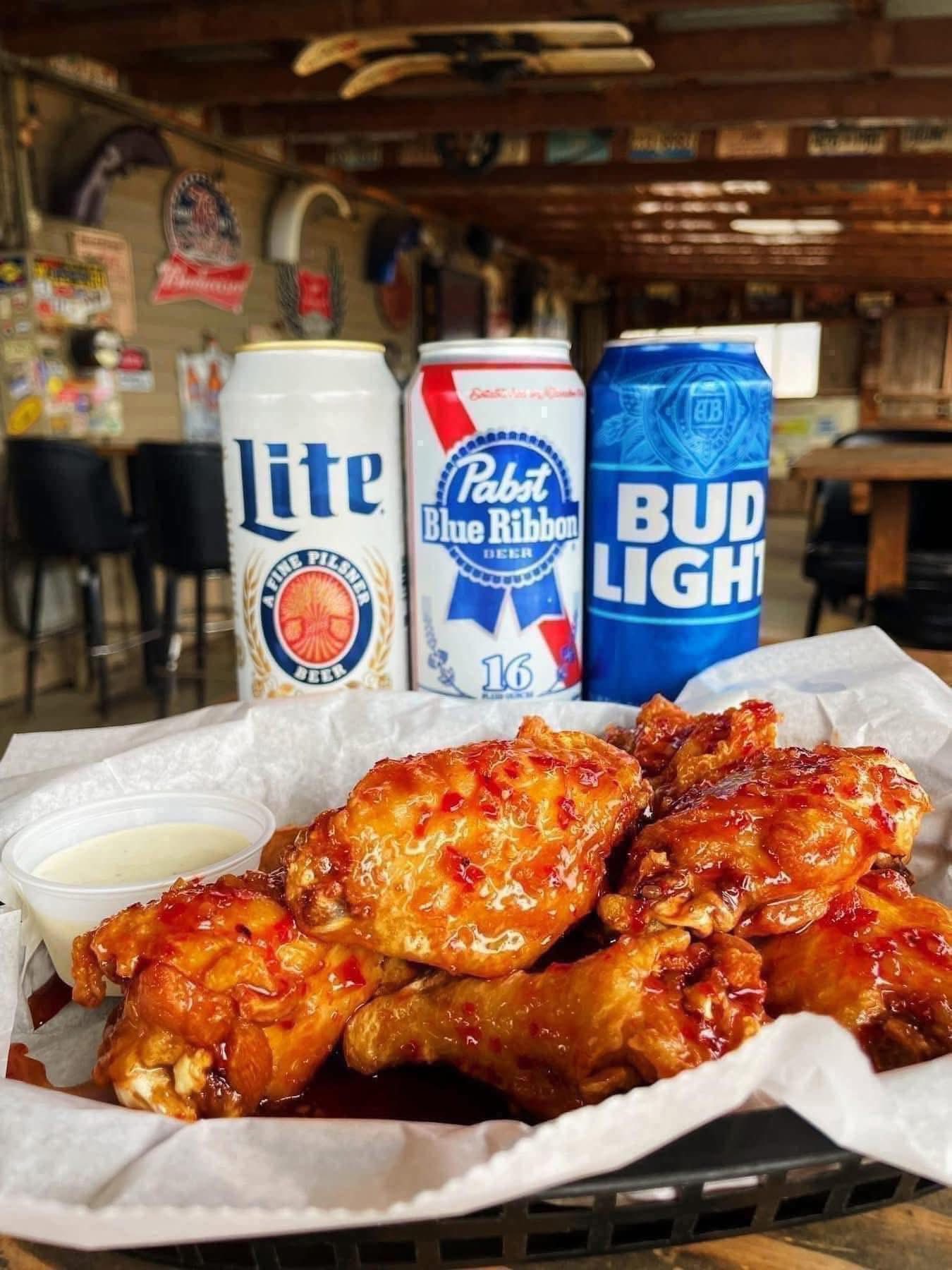 Basket of wings with Lite, PBR, and Bud Light tallboys